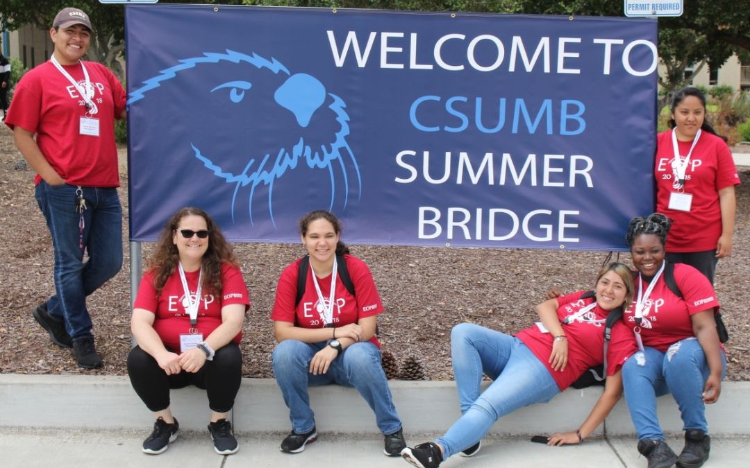 Students Holding Welcome to CSUMB Summer Bridge Sign