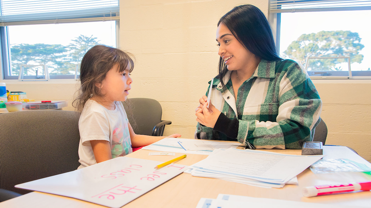 Ashley Arango, right, works with Emely Hernandez at the Reading Center.