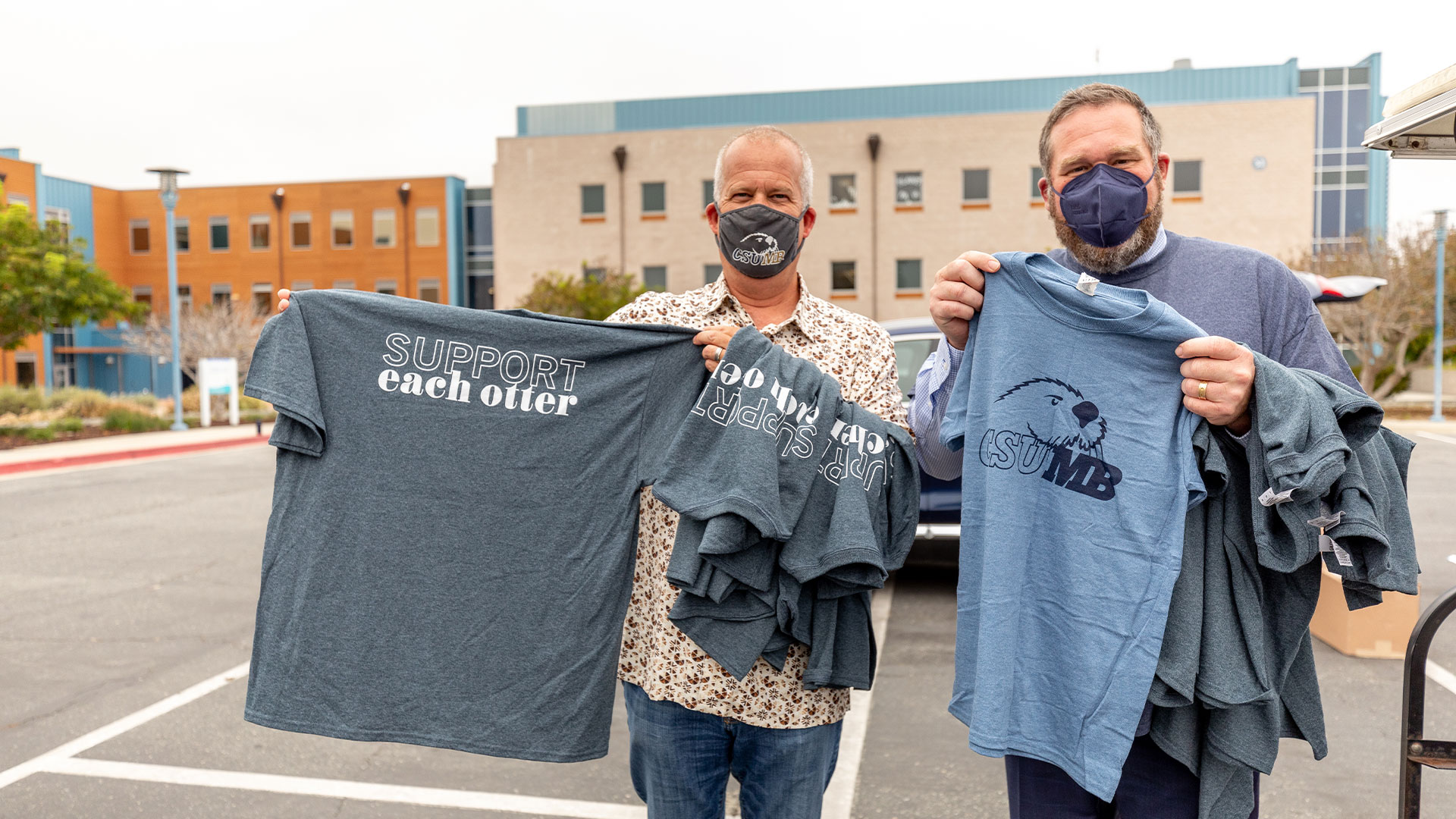 Photo: Chip Lenno and Andrew Drummond holding t-shirts that say 