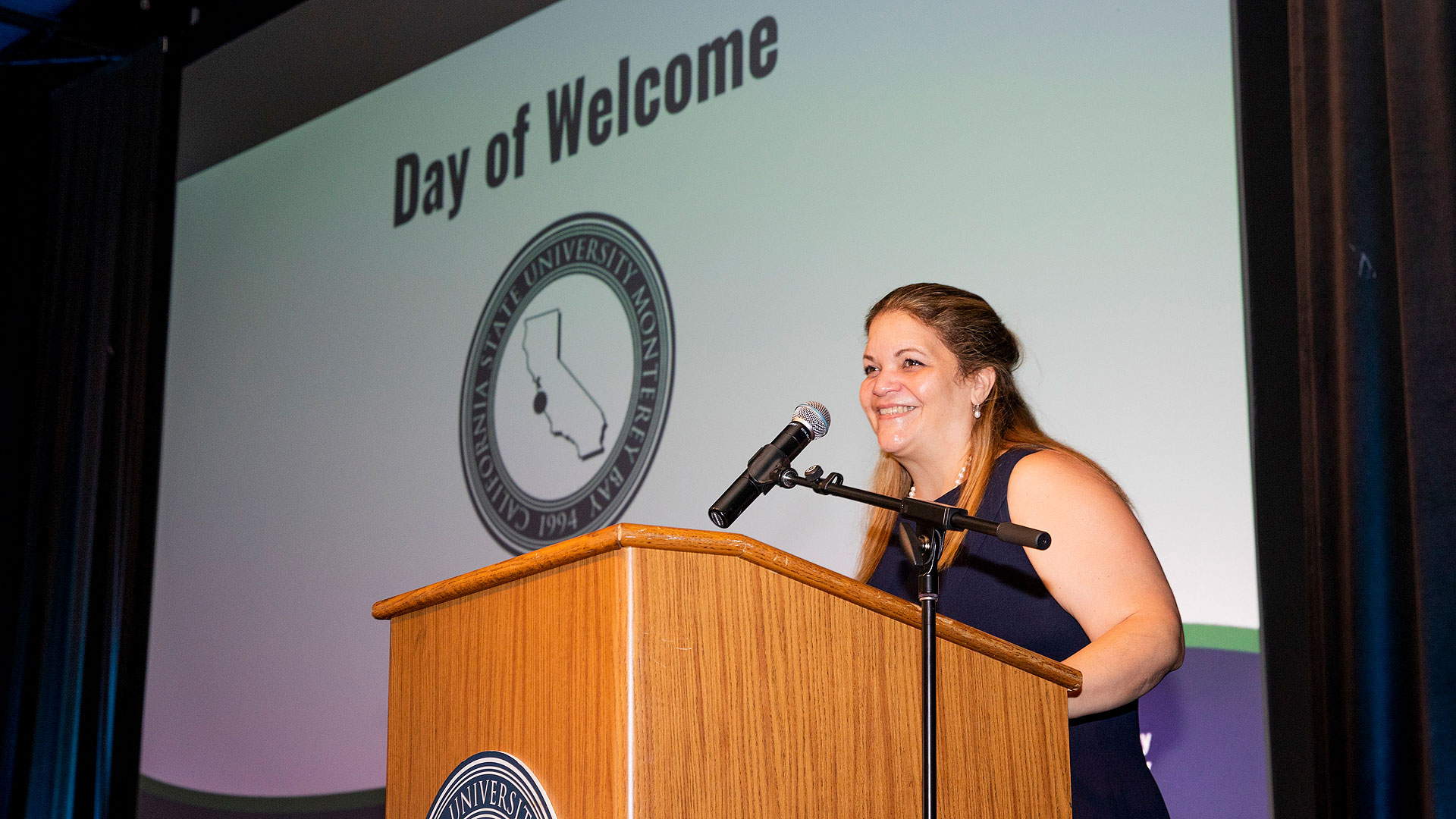 President Quiñones at a podium speaking during the Employee Day of Welcome