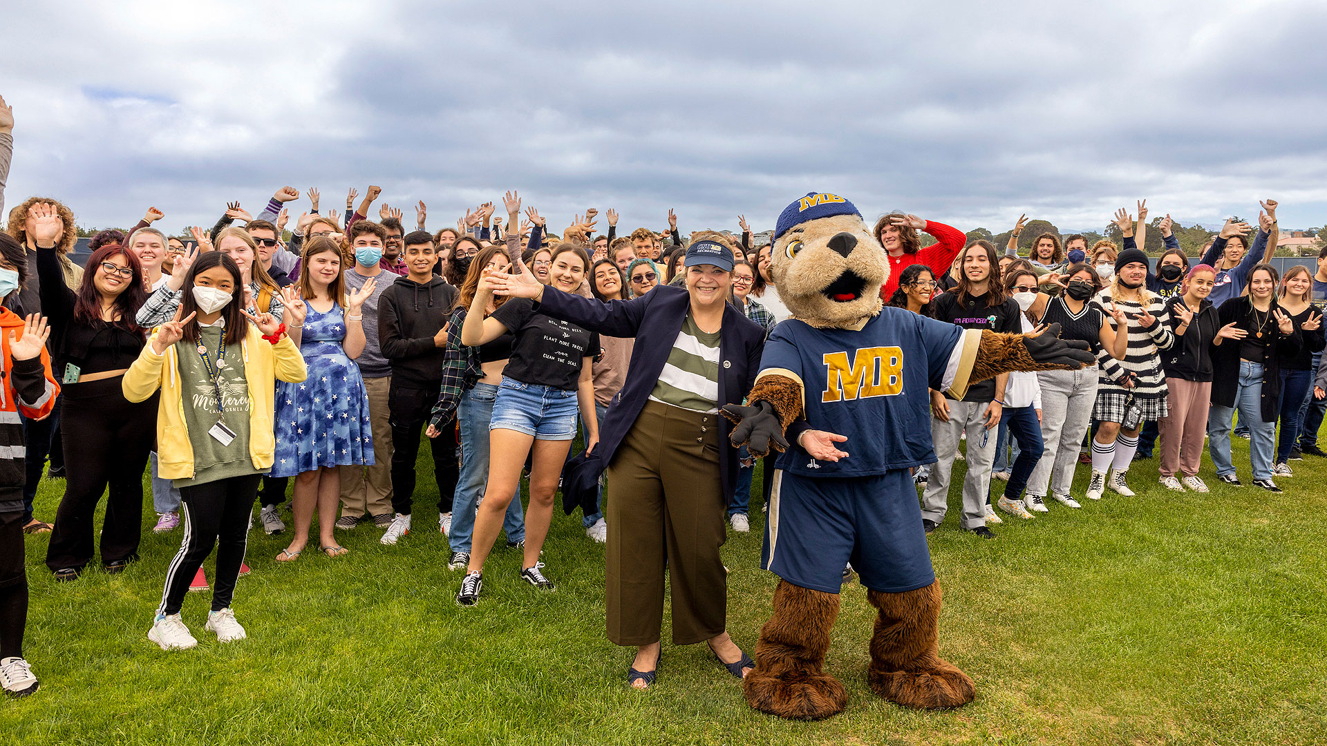 President Quiñones at the Student Convocation with a group of students and Monte the mascot