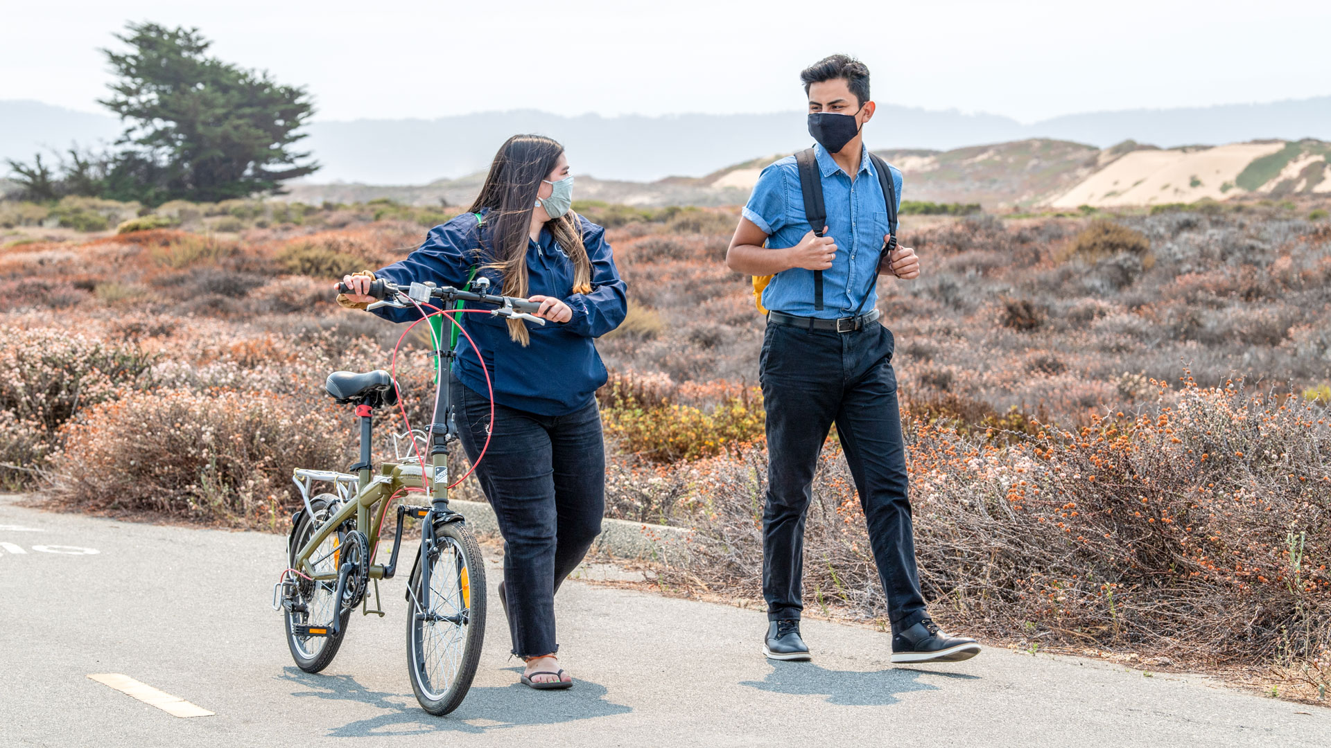 Photo: Students walking through Fort Ord with a bicycle