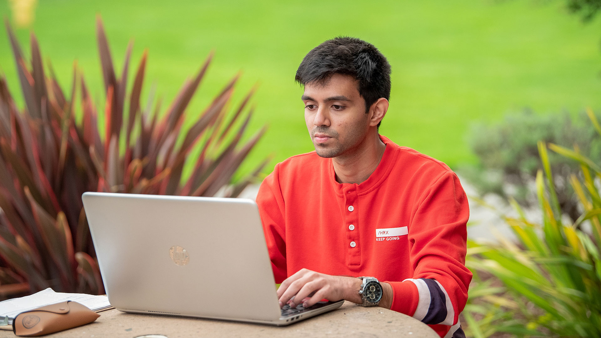 Photo: Student on laptop outside