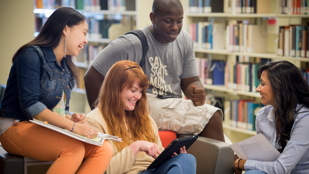 A photo of the CSUMB students reading in the library