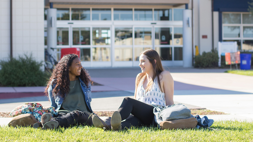 A photo of CSUMB students sitting in front of the University Center