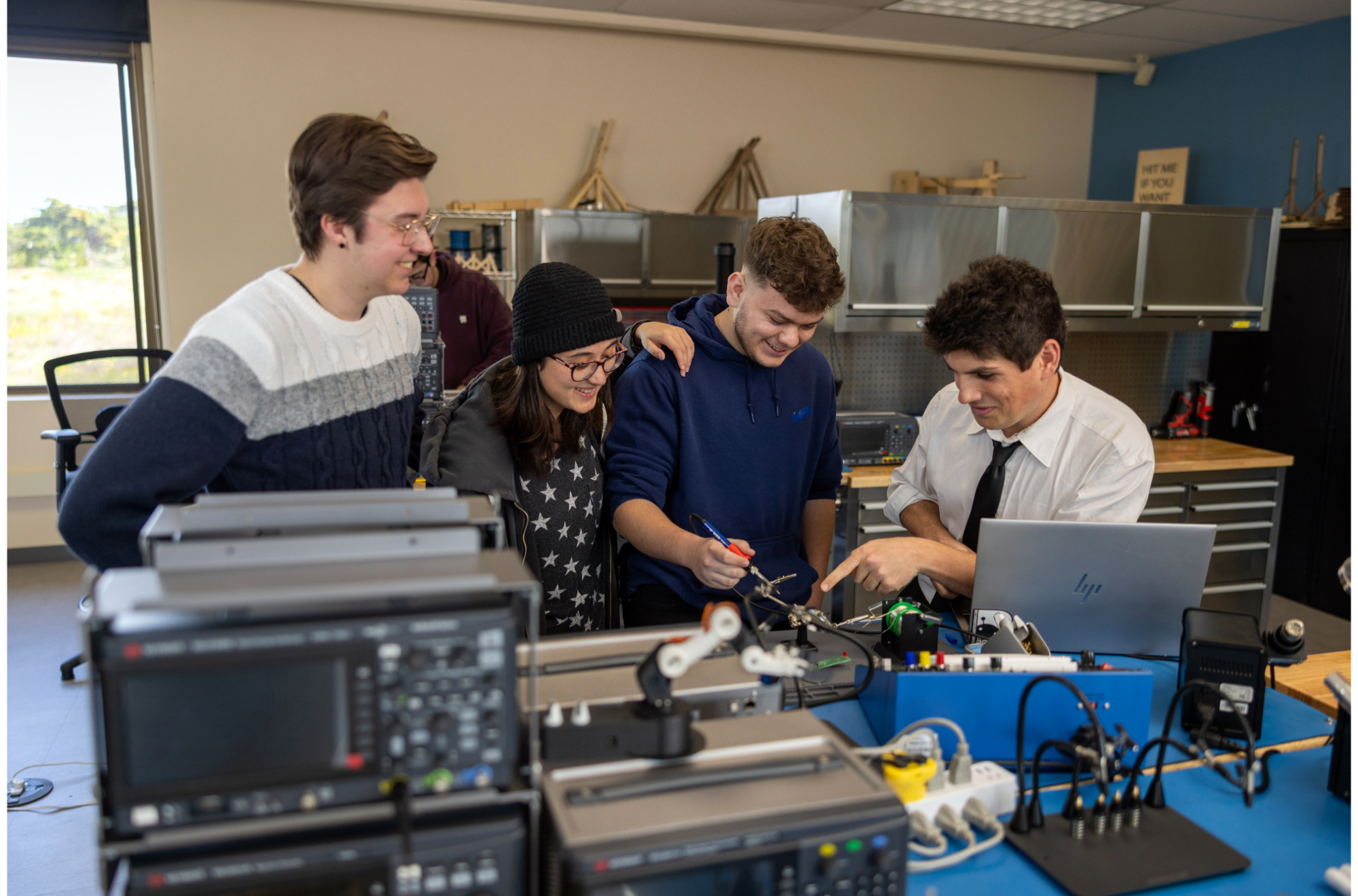 A group of four mechatronics students grouped together collaborating