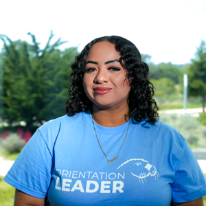 Portrait of an orientation leader standing outdoors on campus
