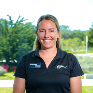 Portrait of an orientation leader standing outdoors on campus.