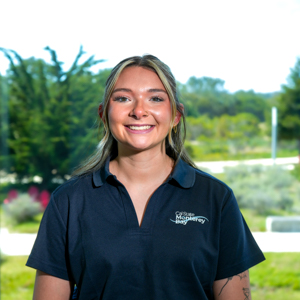 Portrait of an orientation leader standing outdoors on campus.