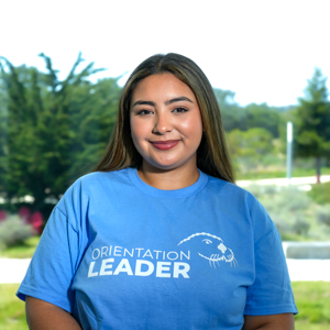 Portrait of an orientation leader standing outdoors on campus.