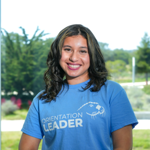 Portrait of an orientation leader standing outdoors on campus.