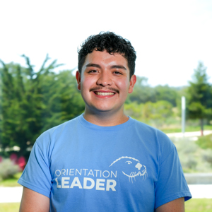 Portrait of an orientation leader standing outdoors on campus.