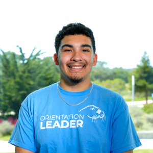 Portrait of an orientation leader standing outdoors on campus.