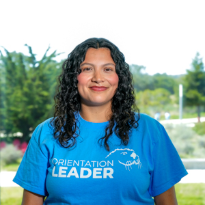 Portrait of an orientation leader standing outdoors on campus.