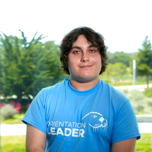 Portrait of an orientation leader standing outdoors on campus.