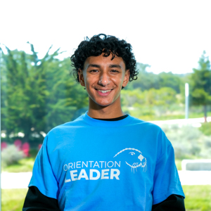 Portrait of an orientation leader standing outdoors on campus.