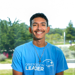 Portrait of an orientation leader standing outdoors on campus.