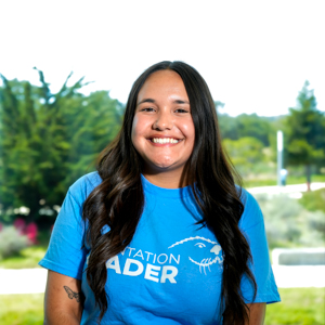 Portrait of an orientation leader standing outdoors on campus.