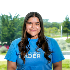 Portrait of an orientation leader standing outdoors on campus.