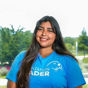 Portrait of an orientation leader standing outdoors on campus.
