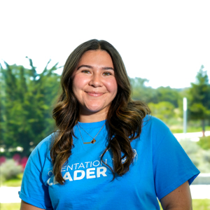 Portrait of an orientation leader standing outdoors on campus.