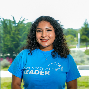 Portrait of an orientation leader standing outdoors on campus.