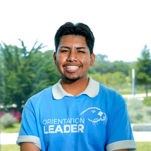Portrait of an orientation leader standing outdoors on campus.