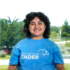 Portrait of an orientation leader standing outdoors on campus.