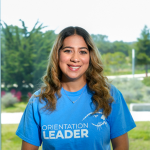 Portrait of an orientation leader standing outdoors on campus.