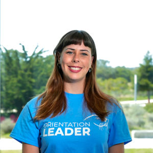 Portrait of an orientation leader standing outdoors on campus.