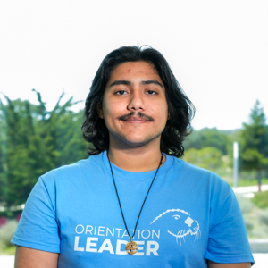 Portrait of an orientation leader standing outdoors on campus.