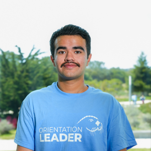 Portrait of an orientation leader standing outdoors on campus.