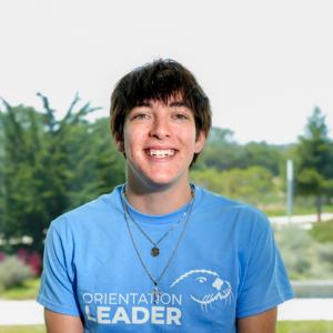 Portrait of an orientation leader standing outdoors on campus.