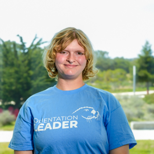 Portrait of an orientation leader standing outdoors on campus.