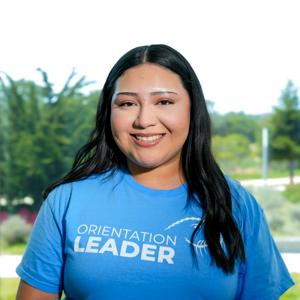 Portrait of an orientation leader standing outdoors on campus.