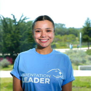 Portrait of an orientation leader standing outdoors on campus.