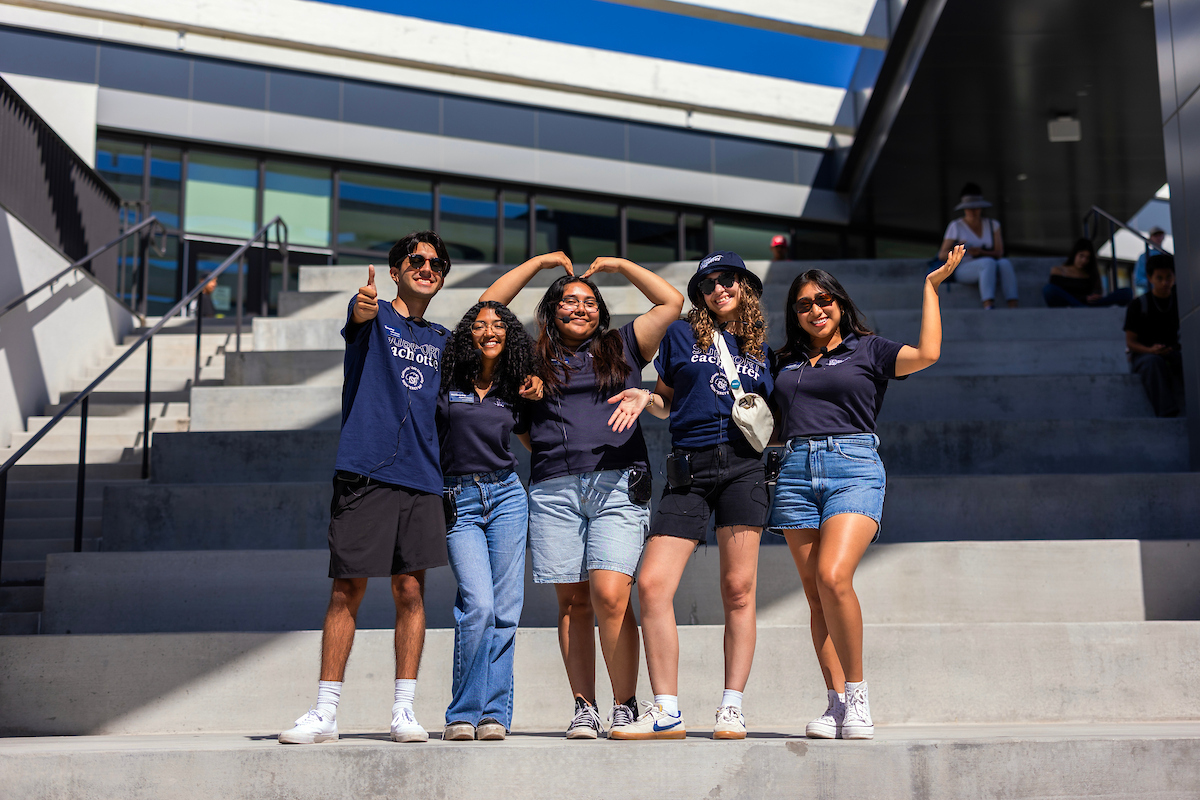 Group of student employees posed together in front of the OSU.
