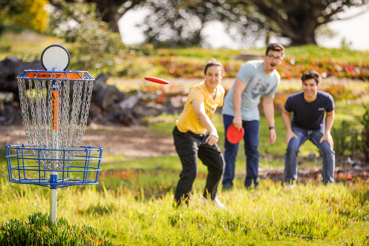 Students playing frisbee golf