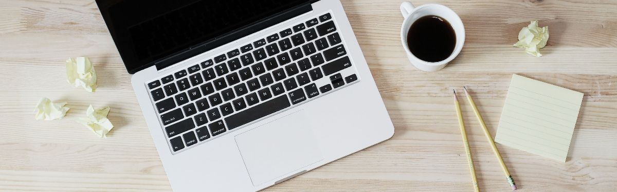 Photo of desk with crumpled up post it notes.