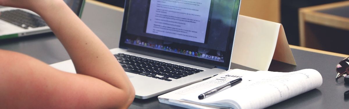 Photo of student doing research on laptop.