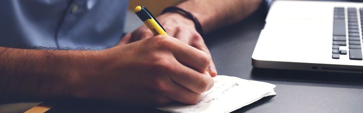 Photo of student writing notes.