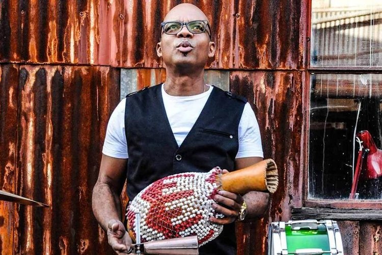 Jesus Diaz holds percussion instrument