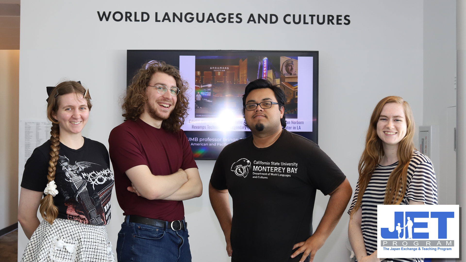 4 students smiling in WLC lobby