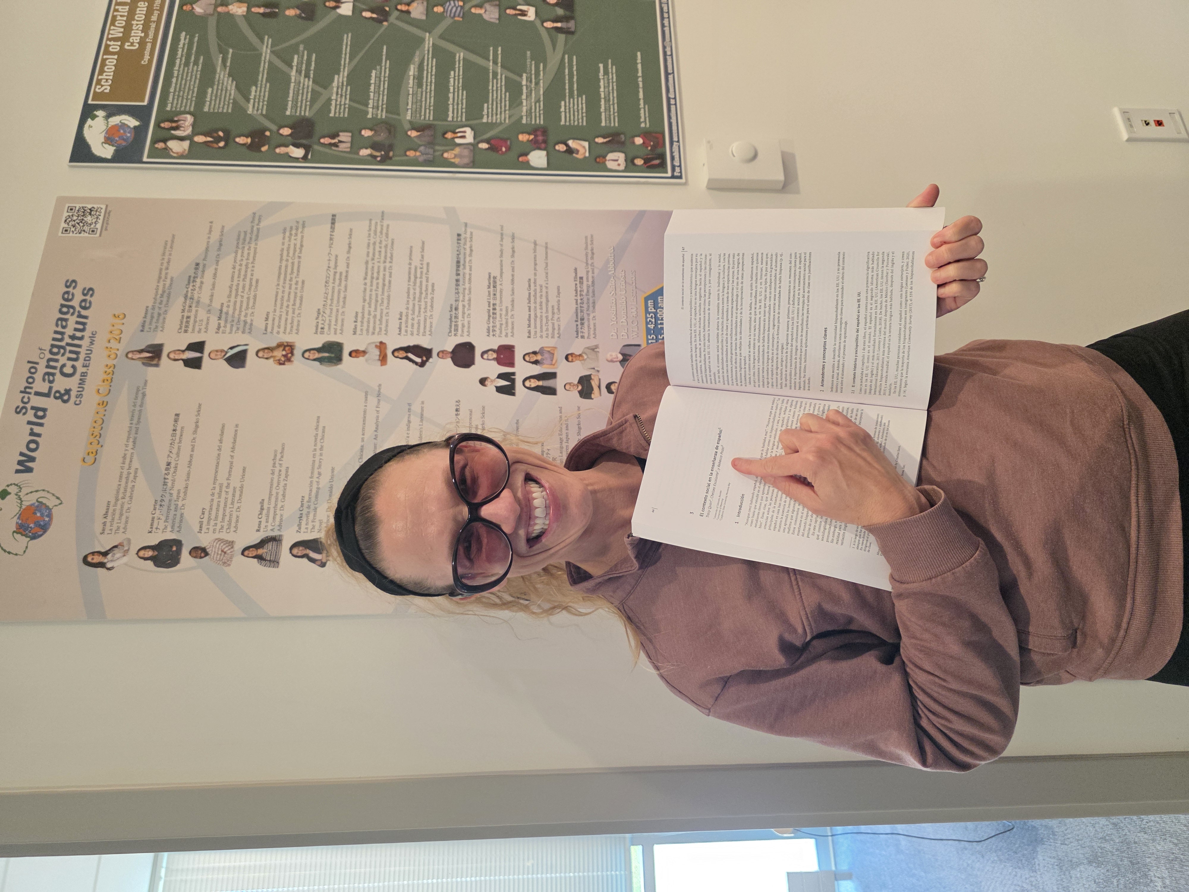 Professor pointing at page in a new publication