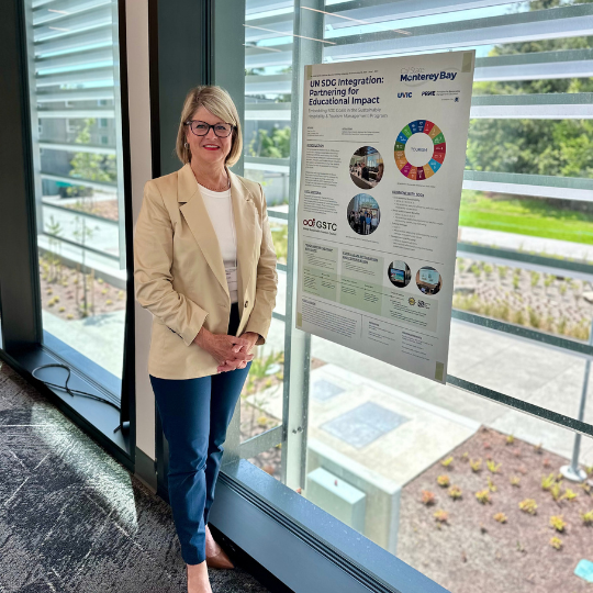 Paige Viren standing next to poster.