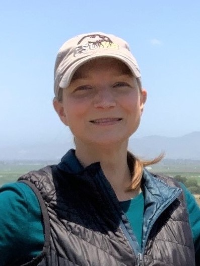 Headshot of Dr. Jennifer Duggan, wearing a CSUMB hat