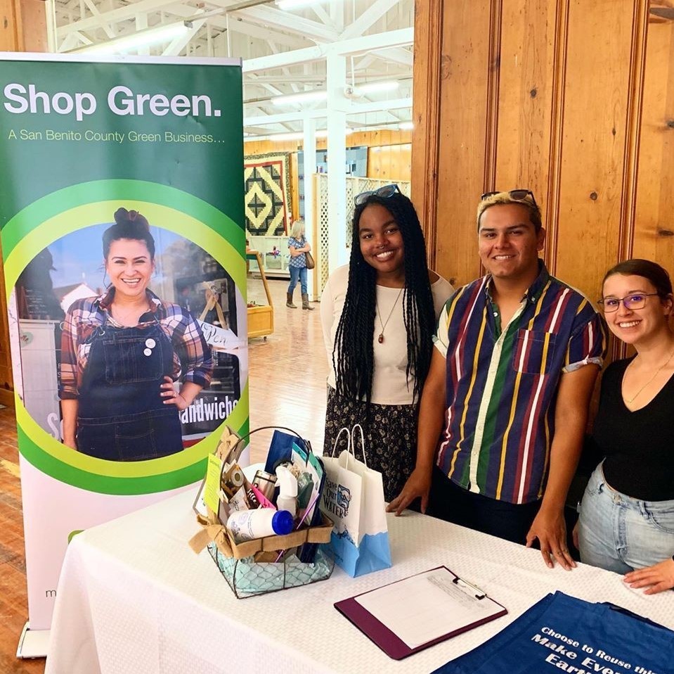 Students stand at a local tabling event