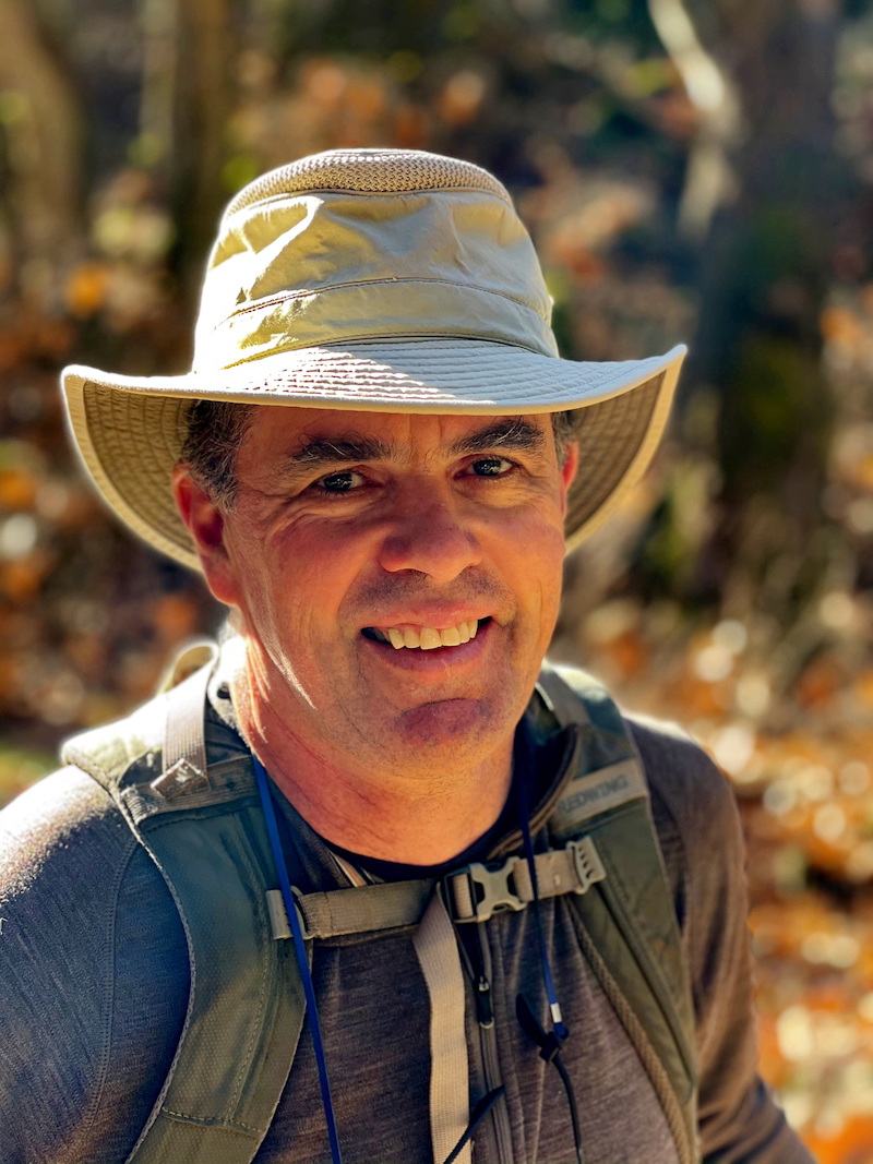 Fred Watson headshot, wearing a hat