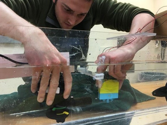 A student working with a marine electronic device