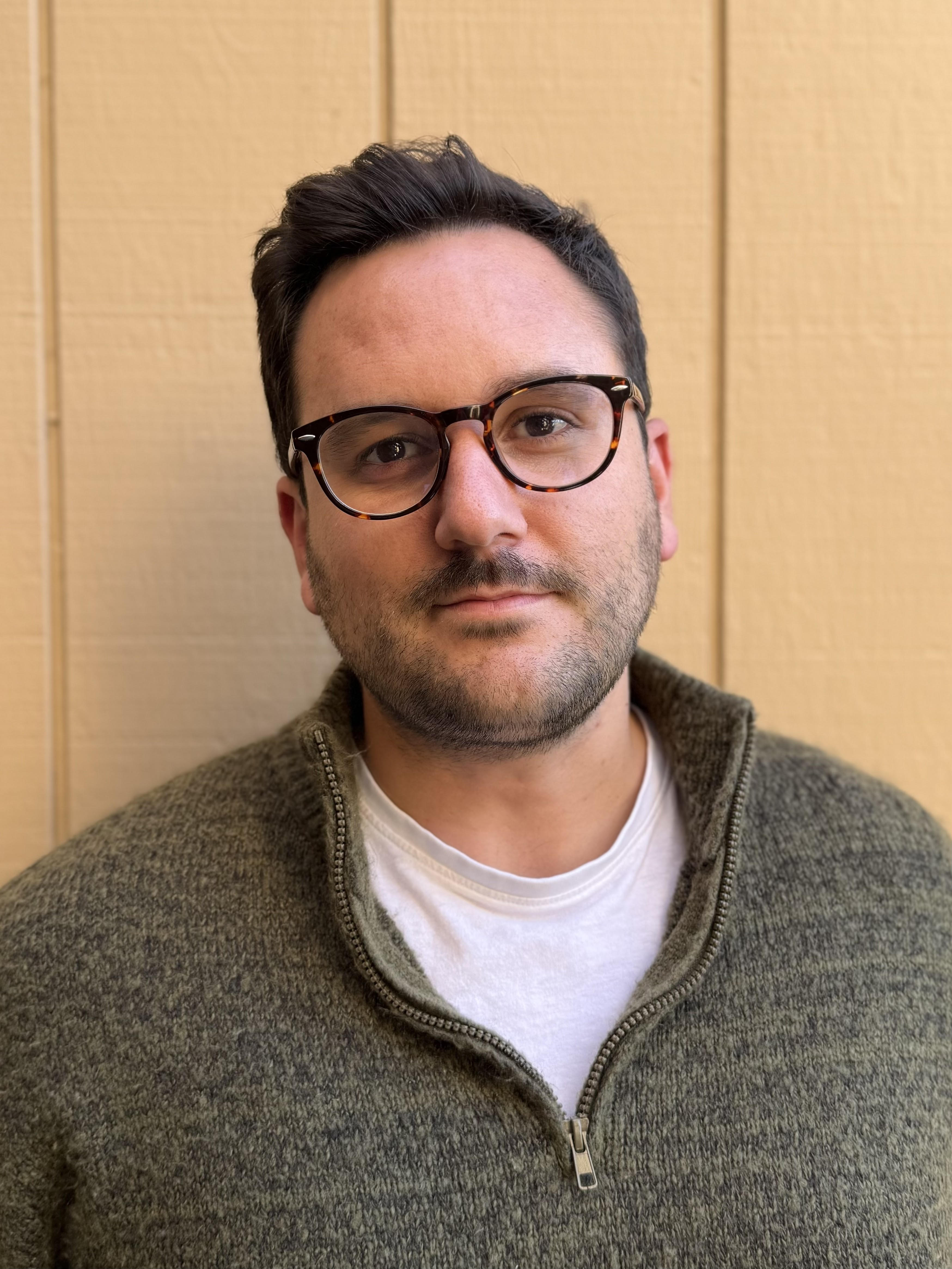 A man with glasses looking at the camera